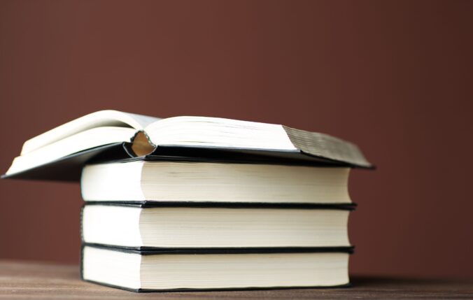 Four books stacked on top one another